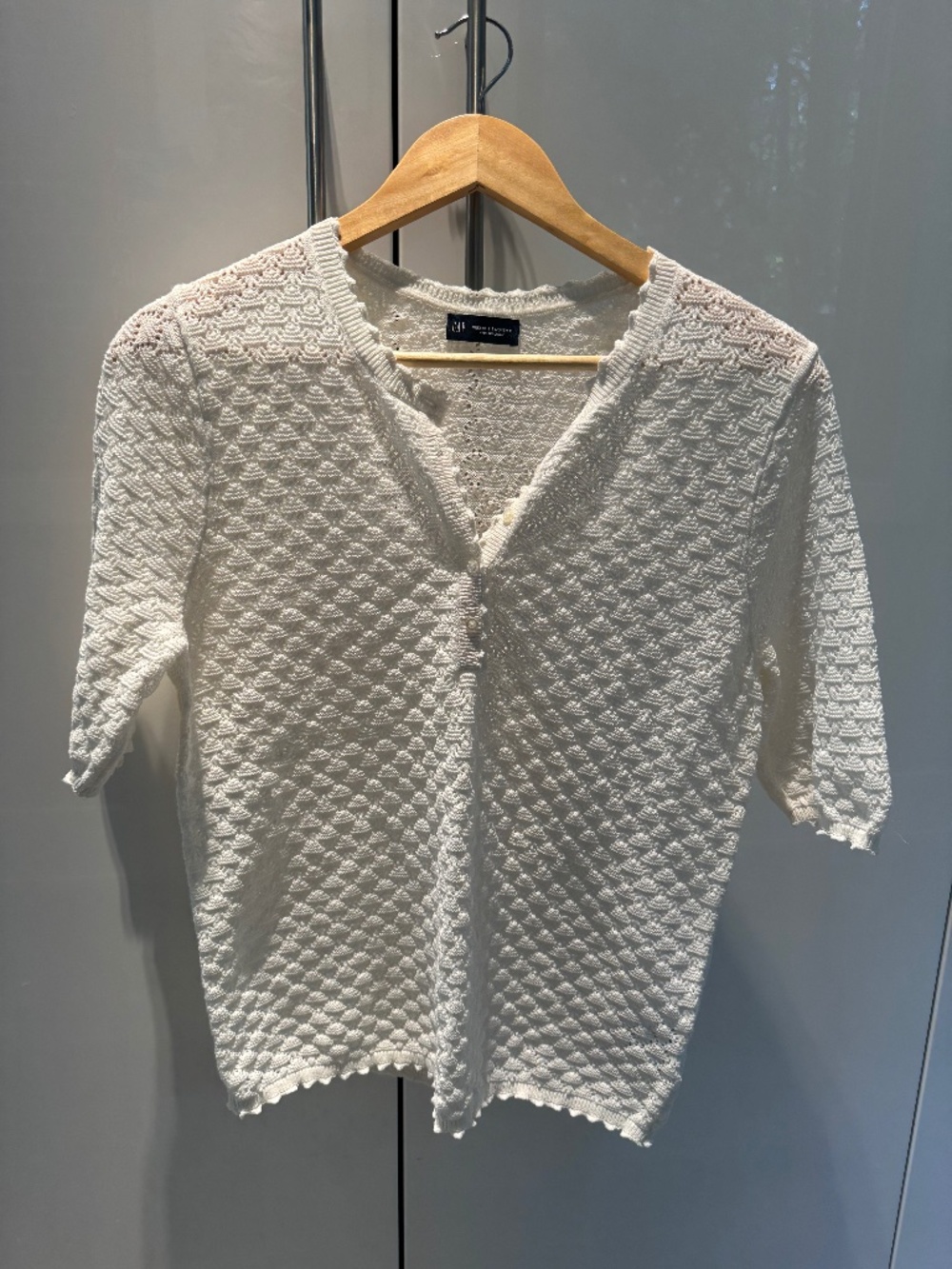 Cream crochet top with buttons.